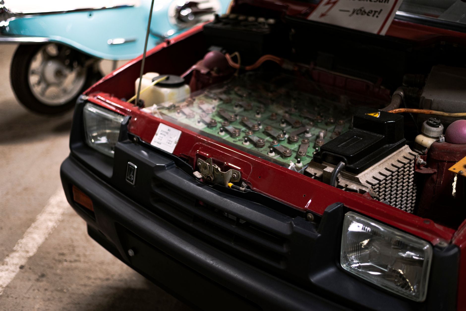 Detailed close-up of a car engine under the hood showcasing various components and connections.