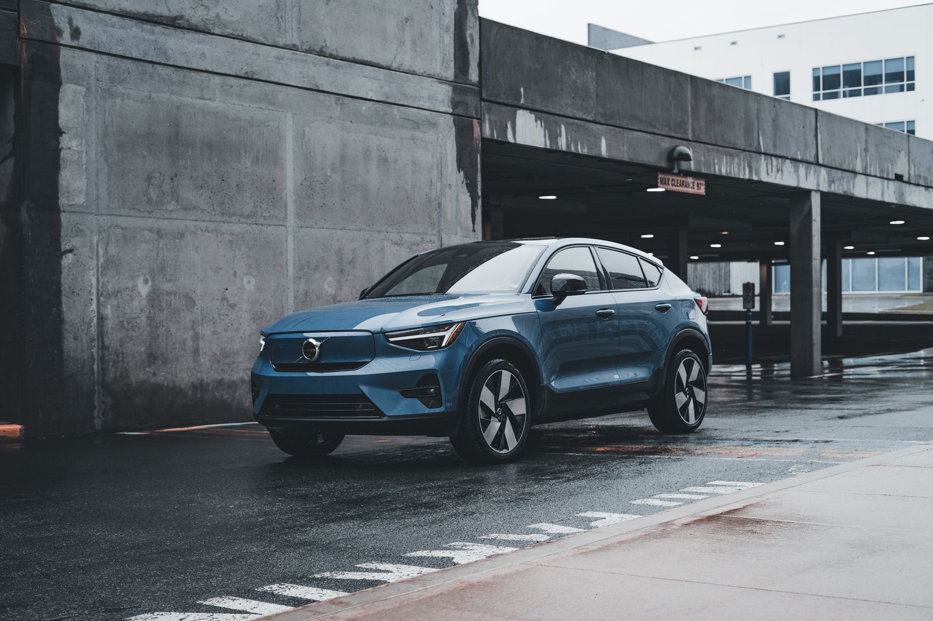 Blue Volvo SUV parked in a modern urban environment showcasing sleek design and urban lifestyle.
