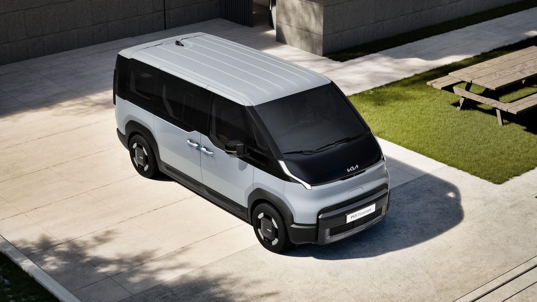 Stylish Kia PV5 electric vehicle parked outdoors in sunlight.