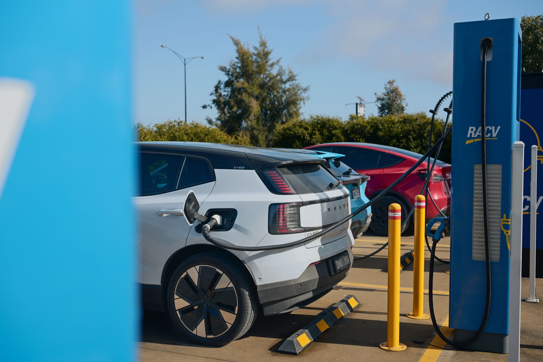 Electric vehicles charging at a RACV station in Barnawartha, VIC, Australia, promoting sustainable transportation.