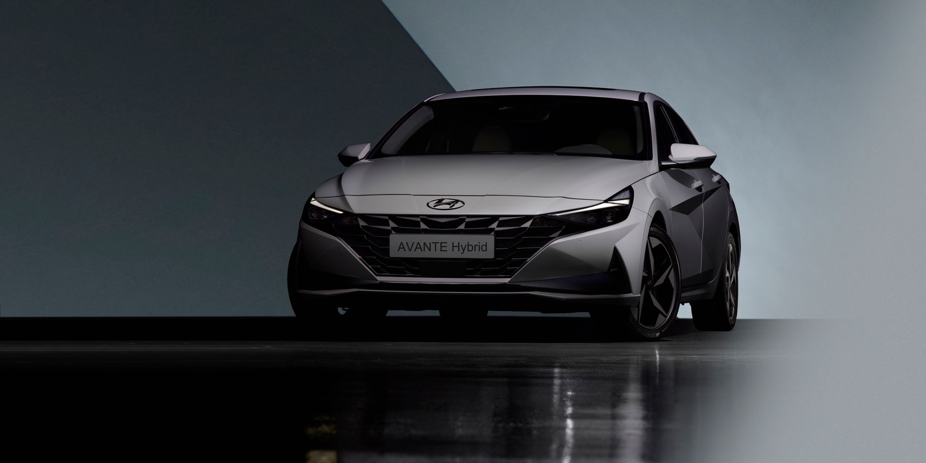 Sleek and modern Hyundai Avante Hybrid sedan displayed in a studio setting.