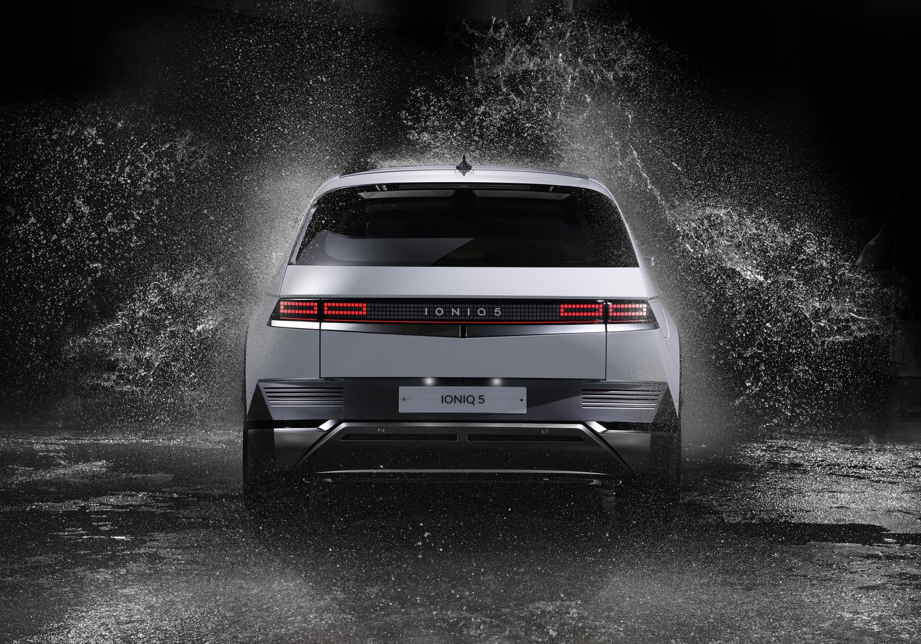 Hyundai Ioniq 5 electric car in a dynamic water splash, studio shot.