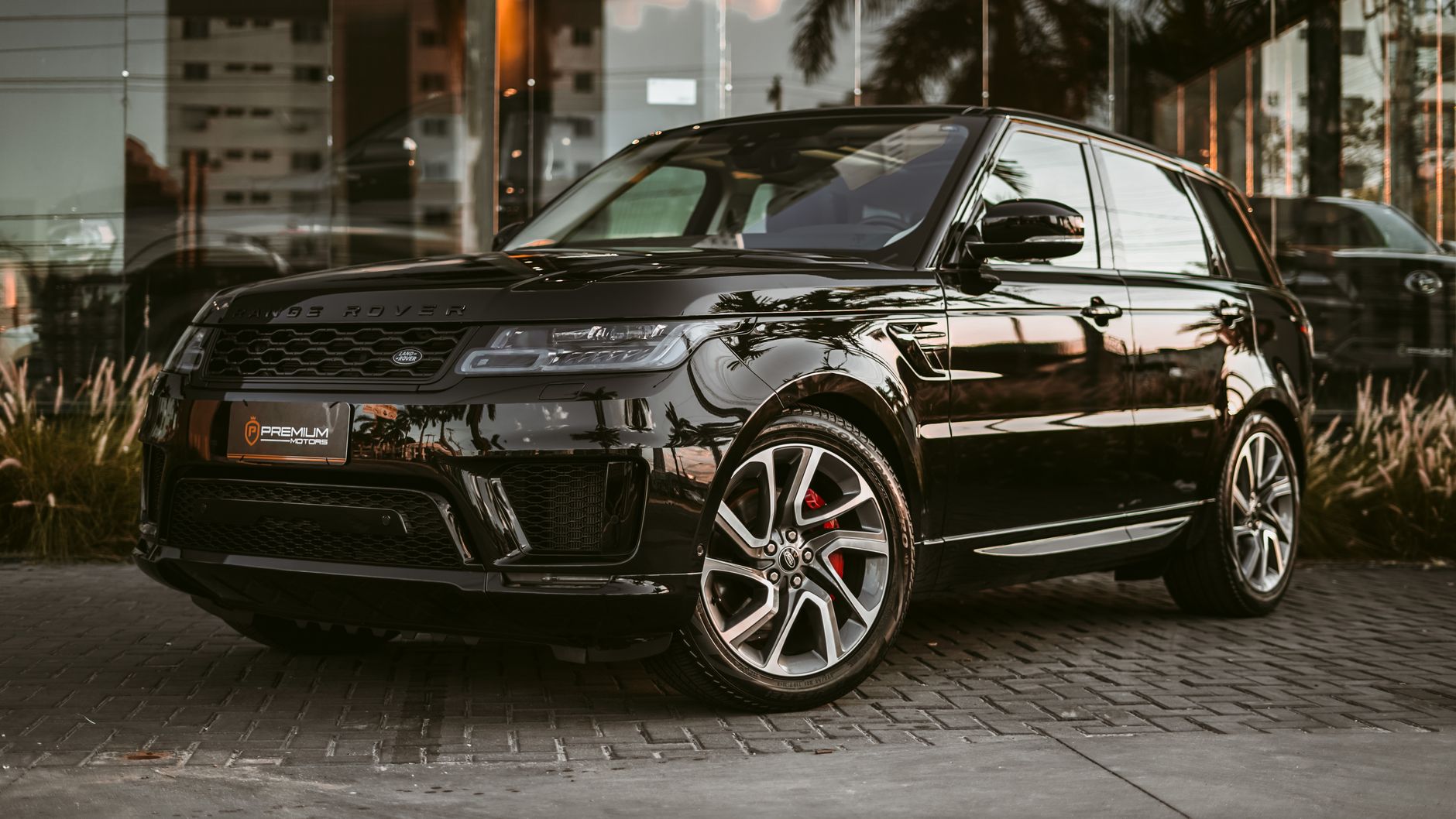 Sleek black SUV parked on a stone pavement, reflecting luxury and style.