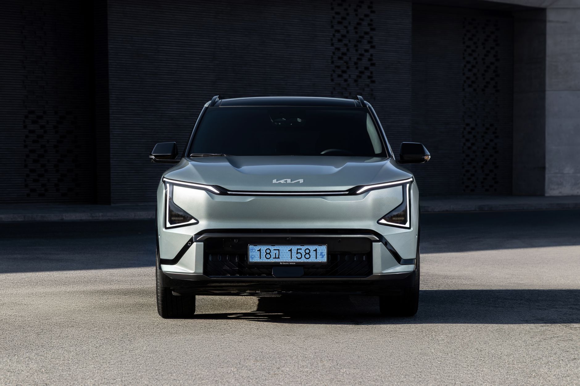 Front view of a sleek and modern Kia EV5 GT-Line vehicle in an urban setting.