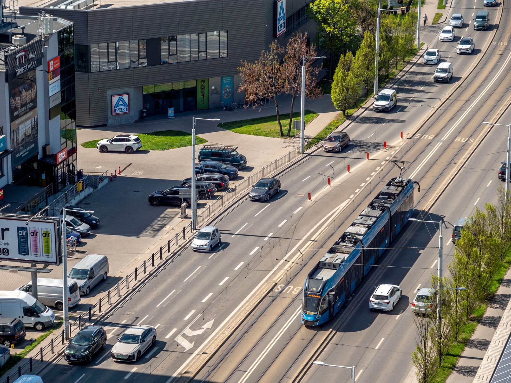 Aerial view of a busy street in Wrocław, Poland with cars and tram traffic.